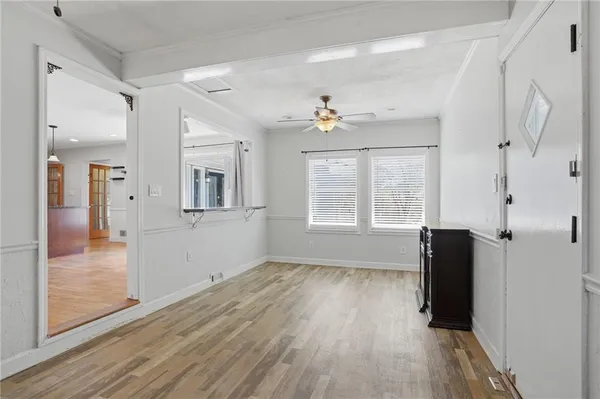 wooden floor in an empty room with a window