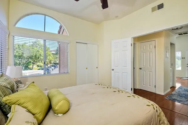 a bedroom with a bed and a large window