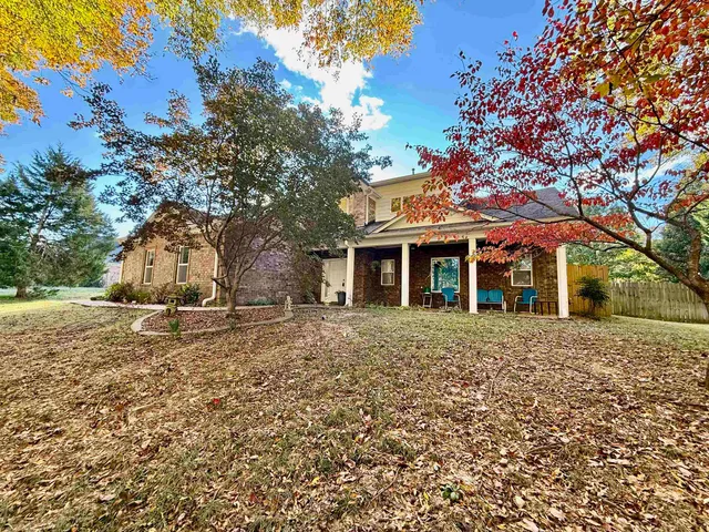 a large tree in front of a house