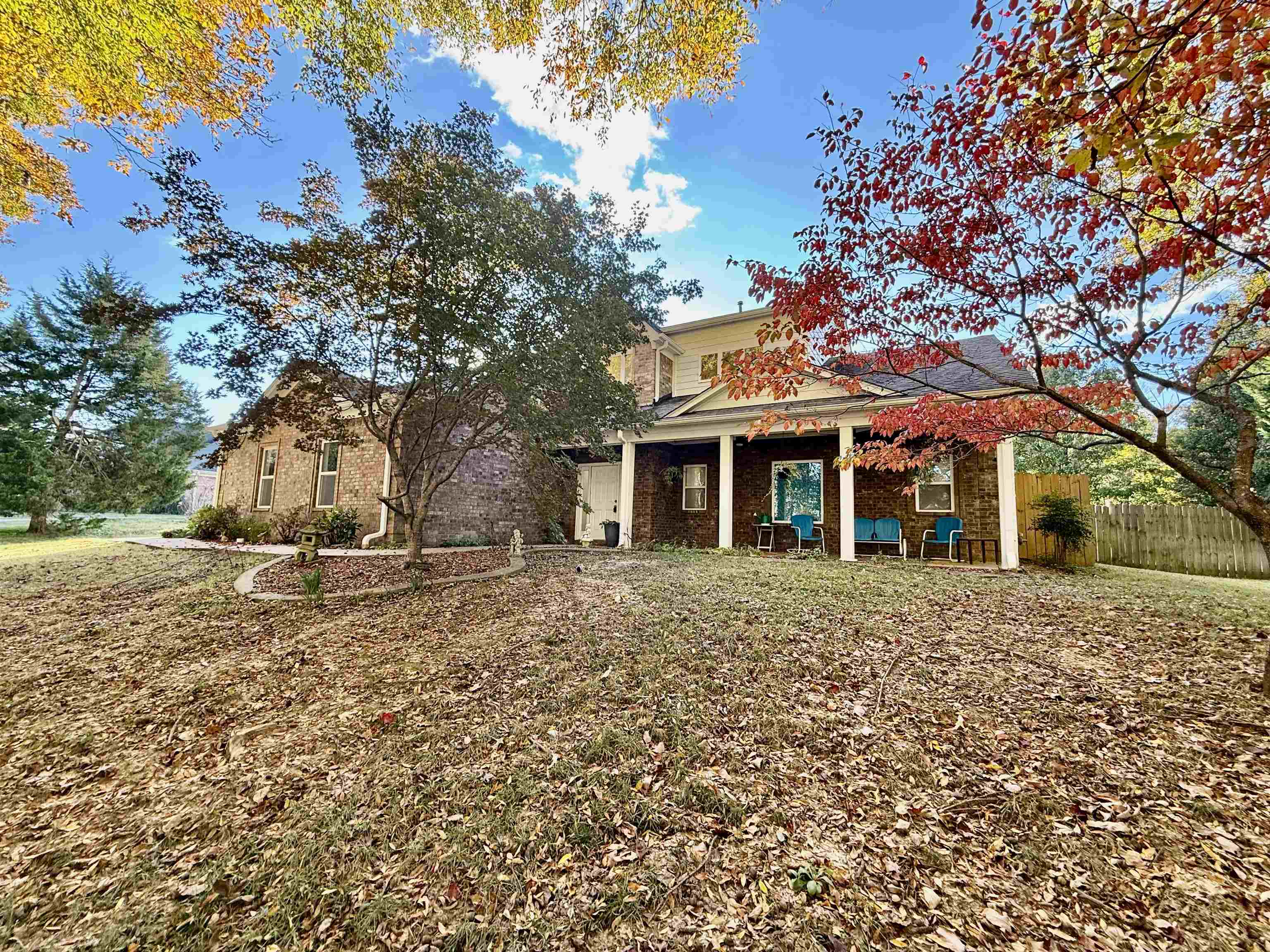 a large tree in front of a house