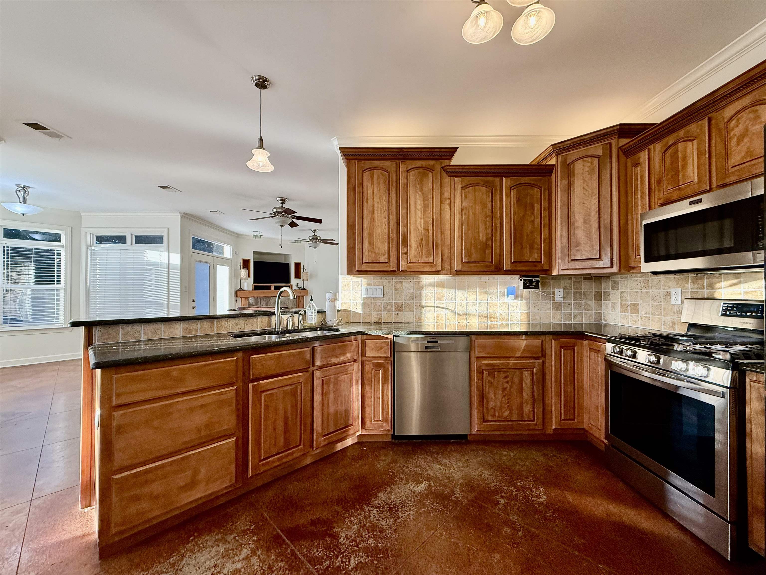2620 Tomlin Road Somerville, TN 38068 - Photo 15 of 40 a kitchen with stainless steel appliances granite countertop wooden cabinets a stove a sink and a microwave