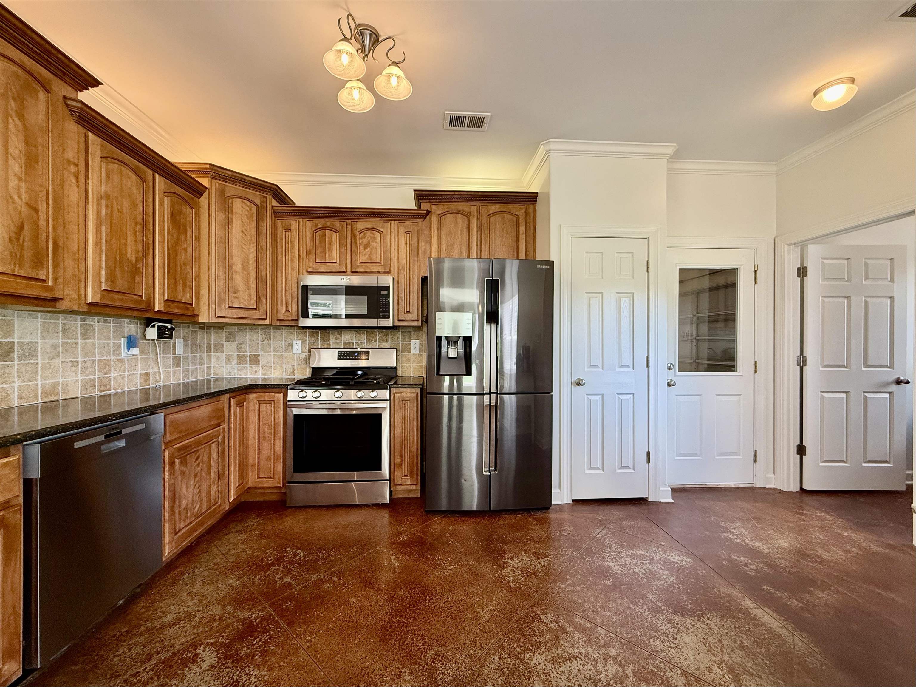 2620 Tomlin Road Somerville, TN 38068 - Photo 16 of 40 a kitchen with stainless steel appliances granite countertop a stove refrigerator and a sink