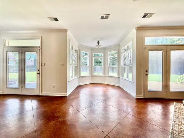 a spacious bedroom with a bed and a chandelier