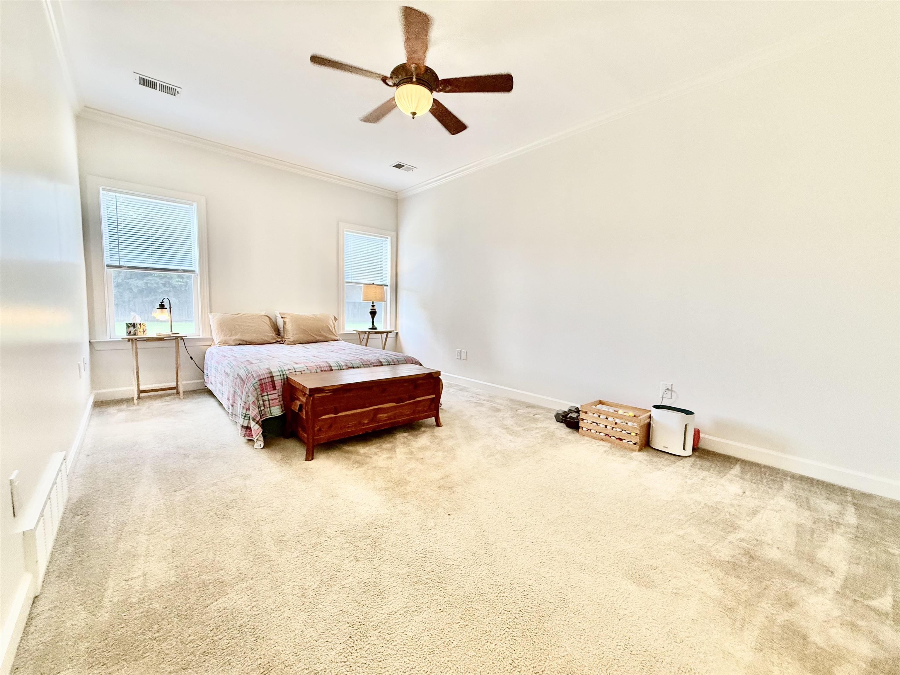 2620 Tomlin Road Somerville, TN 38068 - Photo 21 of 40 a spacious bedroom with a bed and a chandelier