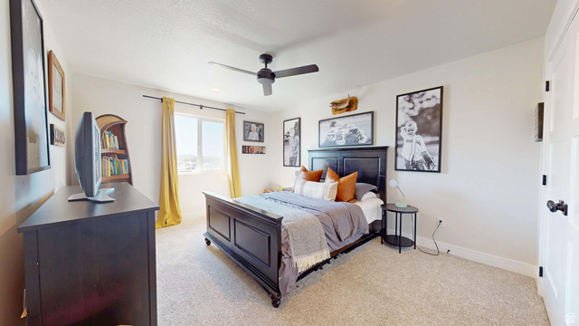 1127 4240 North Enoch, UT 84721 - Photo 40 of 56 Bedroom with light colored carpet and a ceiling fan