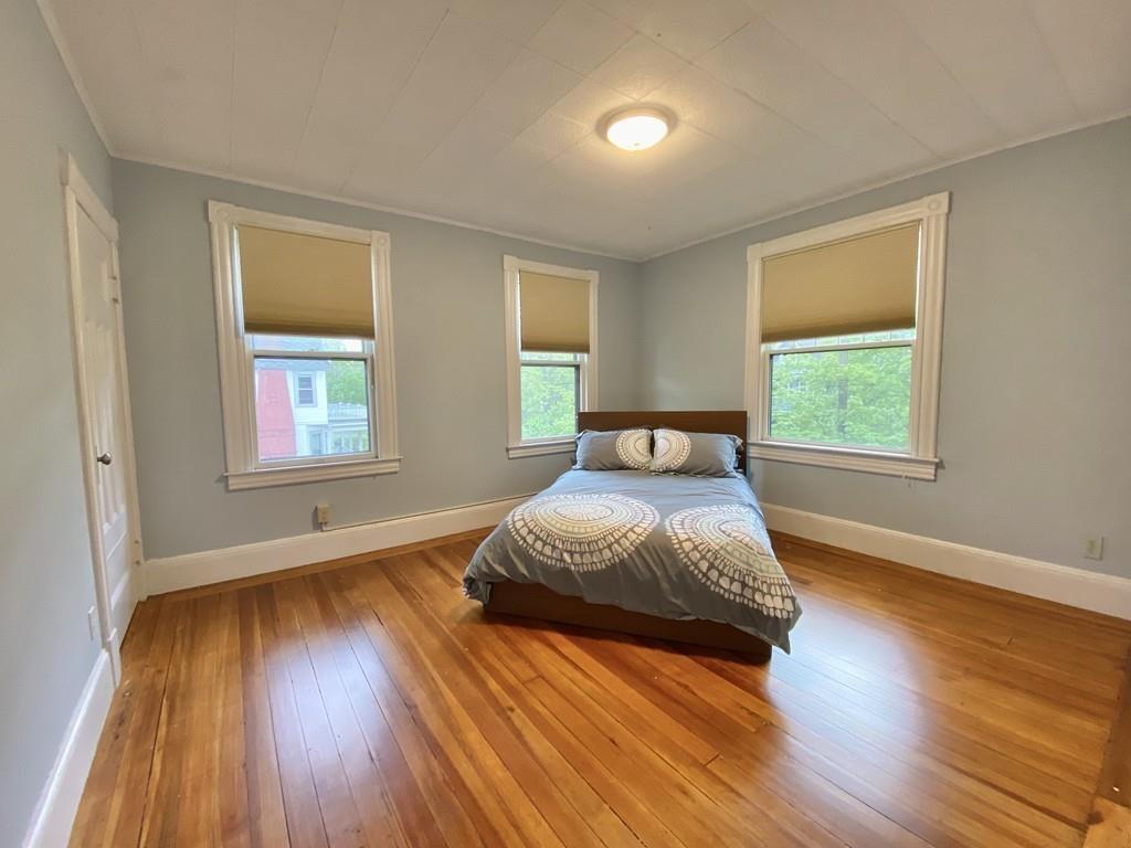 35 Washington Road Springfield, MA 01108 - Photo 23 of 42 a bedroom with a bed and wooden floor