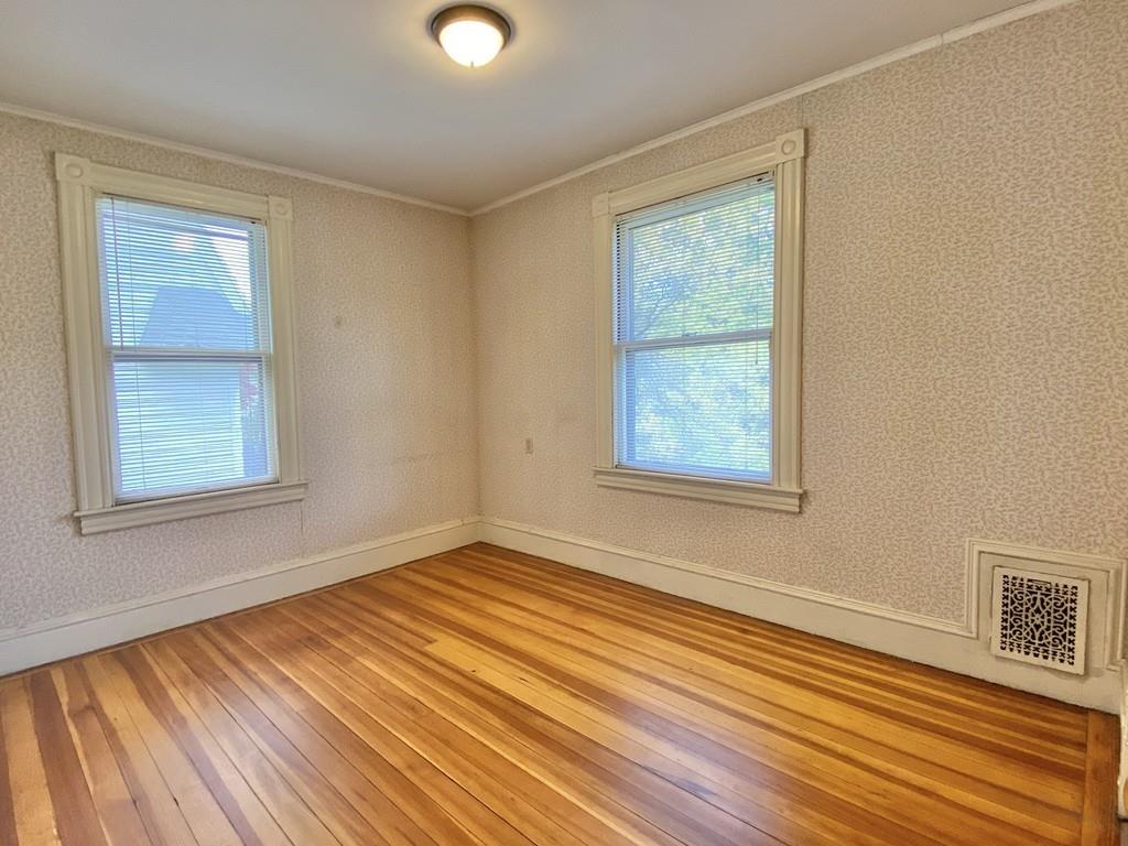 35 Washington Road Springfield, MA 01108 - Photo 27 of 42 a view of an empty room with wooden floor and a window