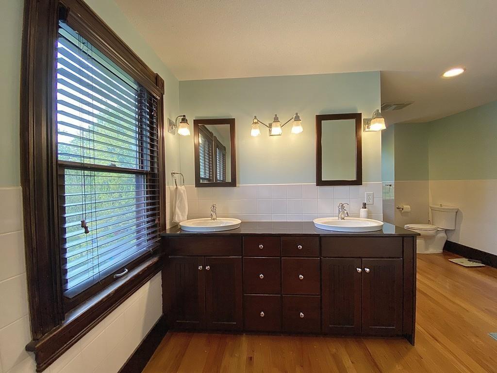 35 Washington Road Springfield, MA 01108 - Photo 32 of 42 a spacious bathroom with a granite countertop sink and mirror