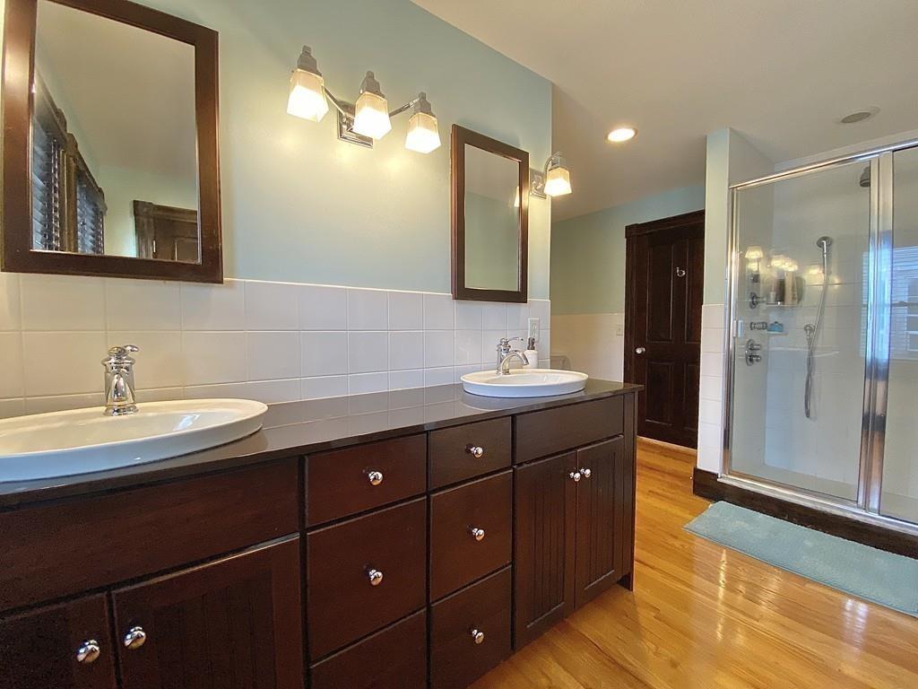 35 Washington Road Springfield, MA 01108 - Photo 33 of 42 a bathroom with a double vanity sink and mirror with shower