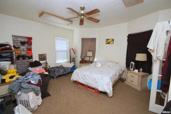 a bedroom with bed and a flat tv screen