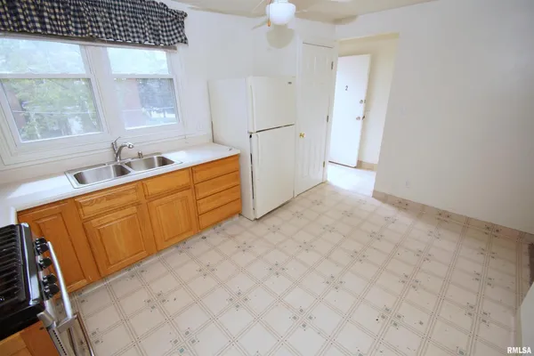 a view of a kitchen with a sink a refrigerator and a stove