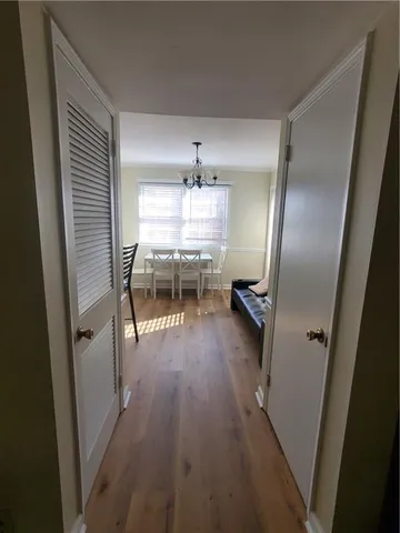 a kitchen with a sink and wooden floor