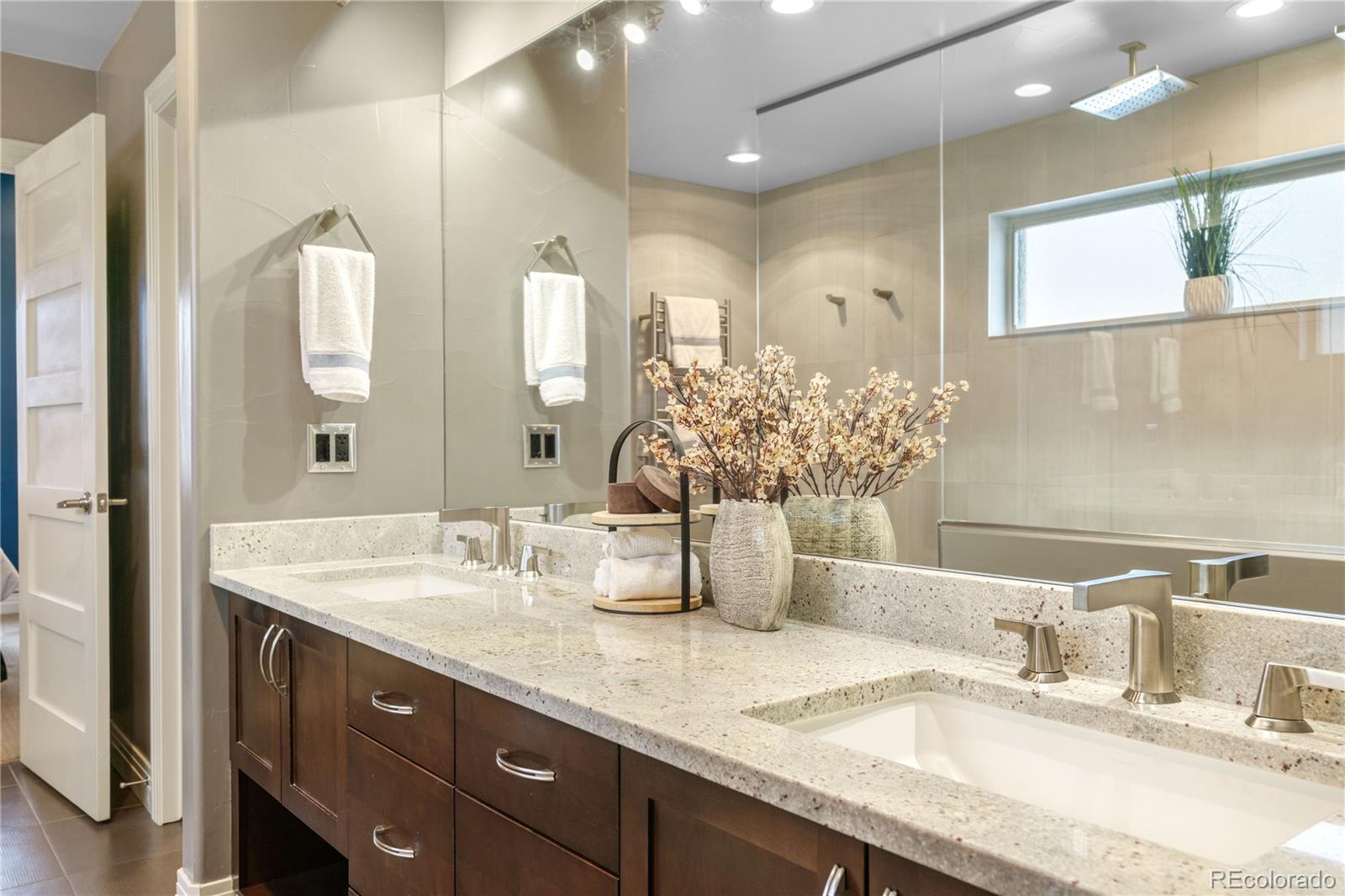 2334 Lowell Boulevard Denver, CO 80211 - Photo 5 of 42 a bathroom with double vanity sinks and a large mirror