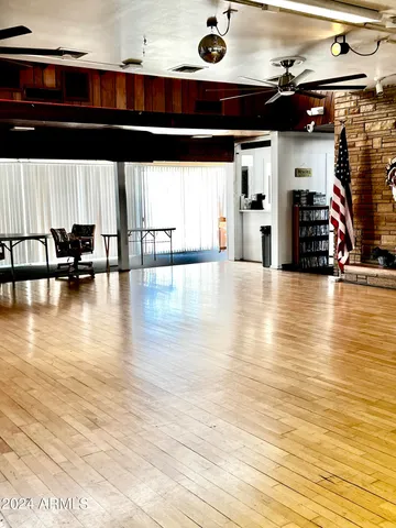 a view of an empty room with furniture and wooden floor