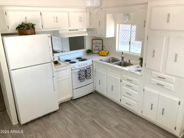 a kitchen with appliances a sink and a cabinets