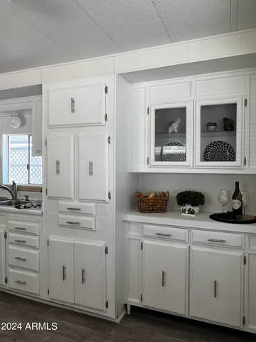 a view of cabinets a wooden floor and windows