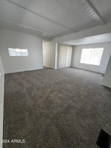 a view of an empty room and a window