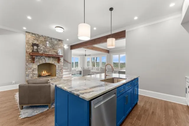 a bathroom with a bathtub a mirror a sink and large window