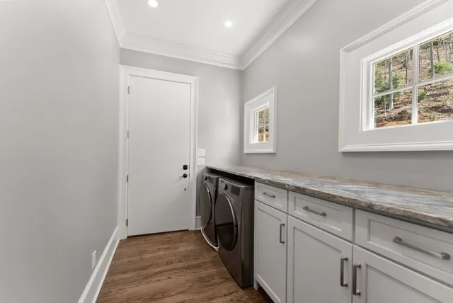 a bathroom with a granite countertop sink a toilet and a shower