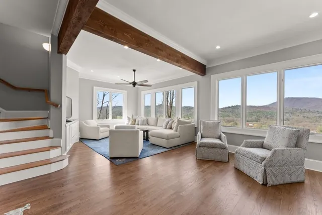 a view of an empty room with a chandelier fan