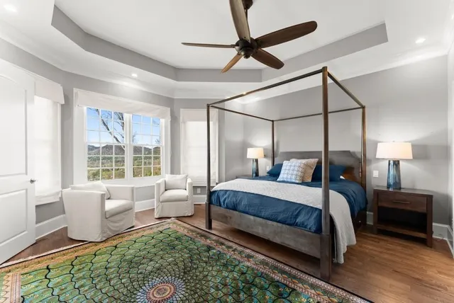 a bathroom with a granite countertop sink a toilet and a mirror