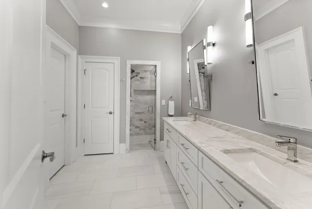 a large bed sitting in a bedroom next to a window