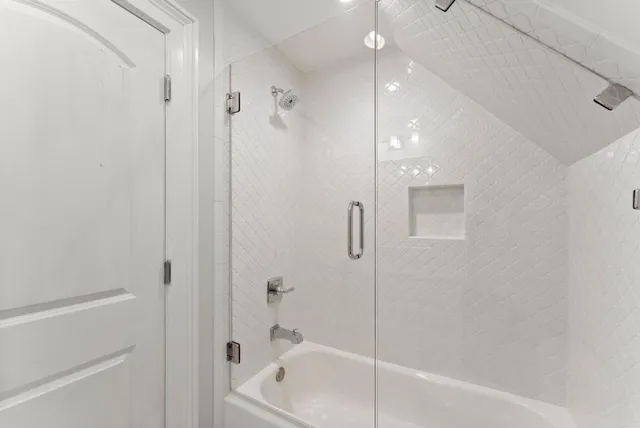 a bathroom with a granite countertop sink a toilet and shower