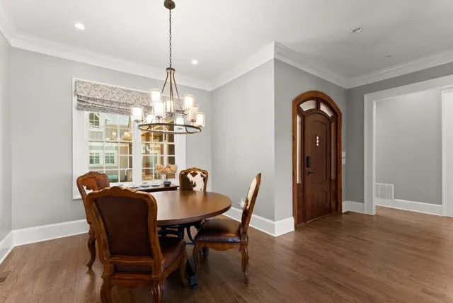 a large kitchen with granite countertop a stove and a wooden floors