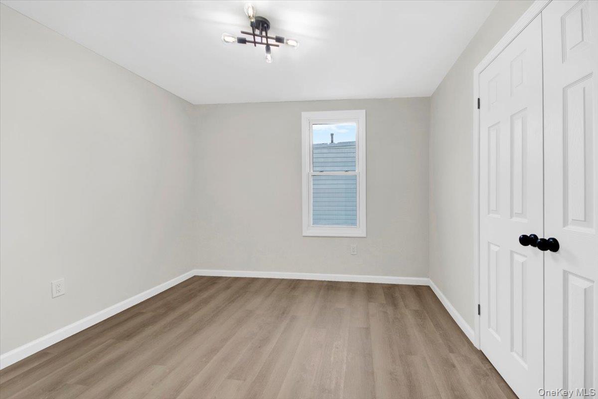 1625 Overing Street Bronx, NY 10461 - Photo 14 of 25 wooden floor in an empty room with a window