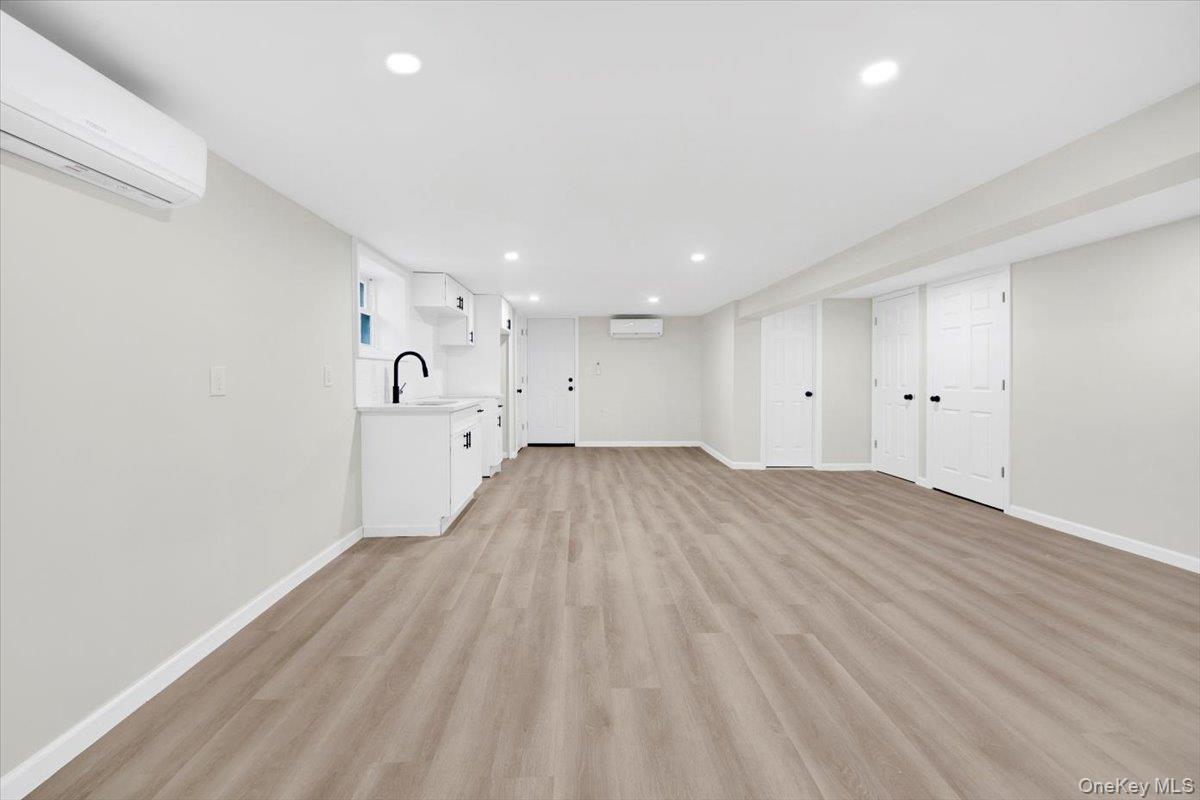 1625 Overing Street Bronx, NY 10461 - Photo 19 of 25 a view of a big room with wooden floor and windows