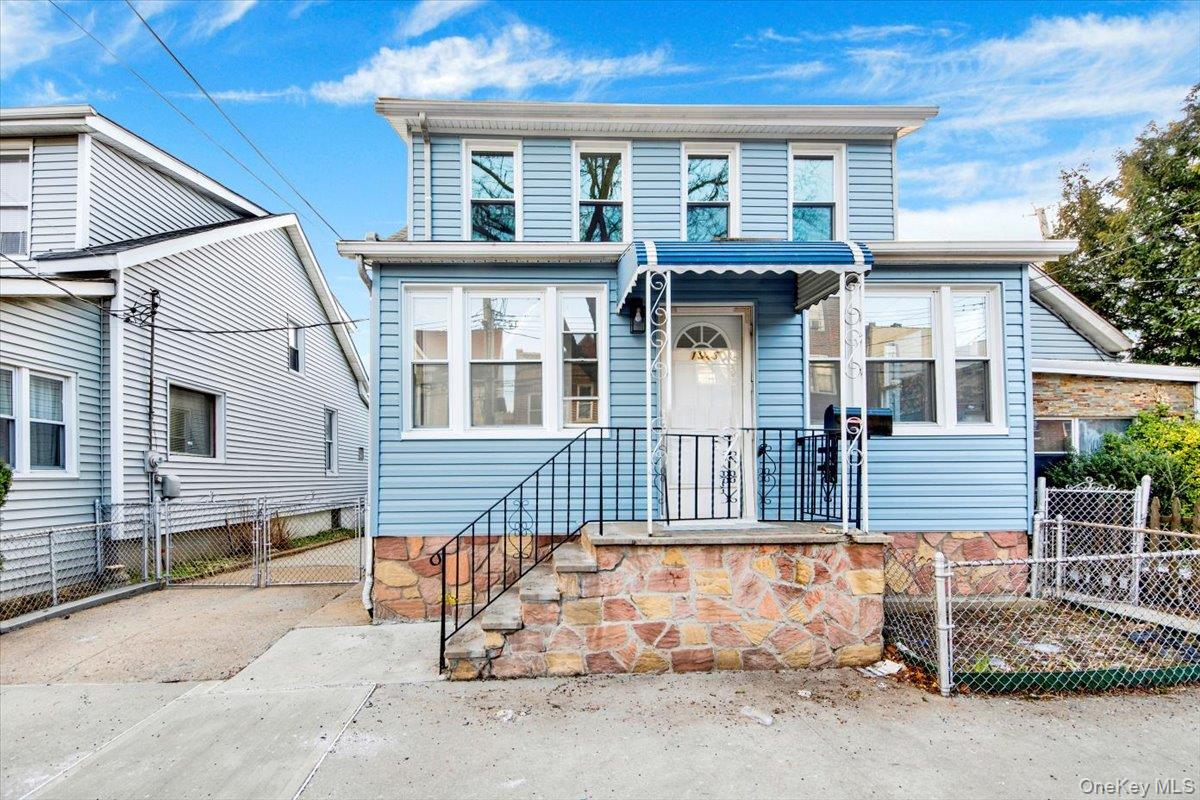 1625 Overing Street Bronx, NY 10461 - Photo 2 of 25 a view of a white house with iron fence