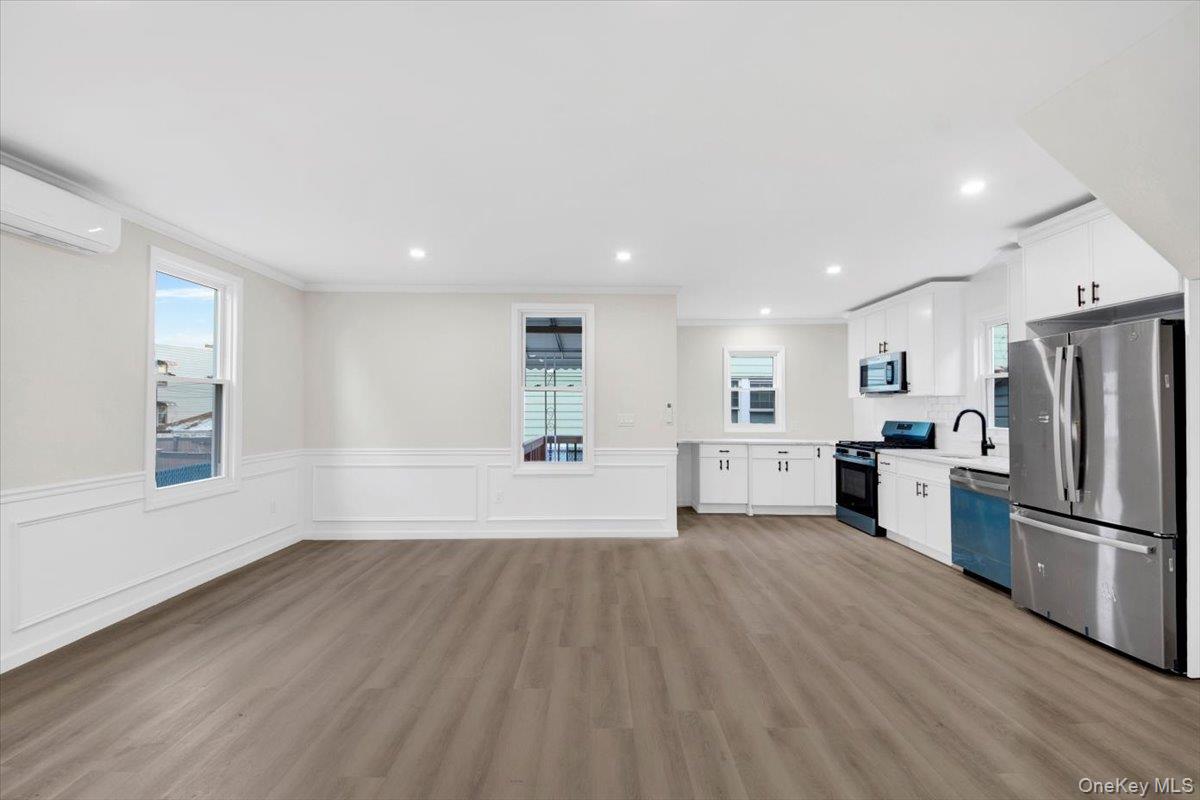 1625 Overing Street Bronx, NY 10461 - Photo 4 of 25 a view of a kitchen with a fridge and wooden floor
