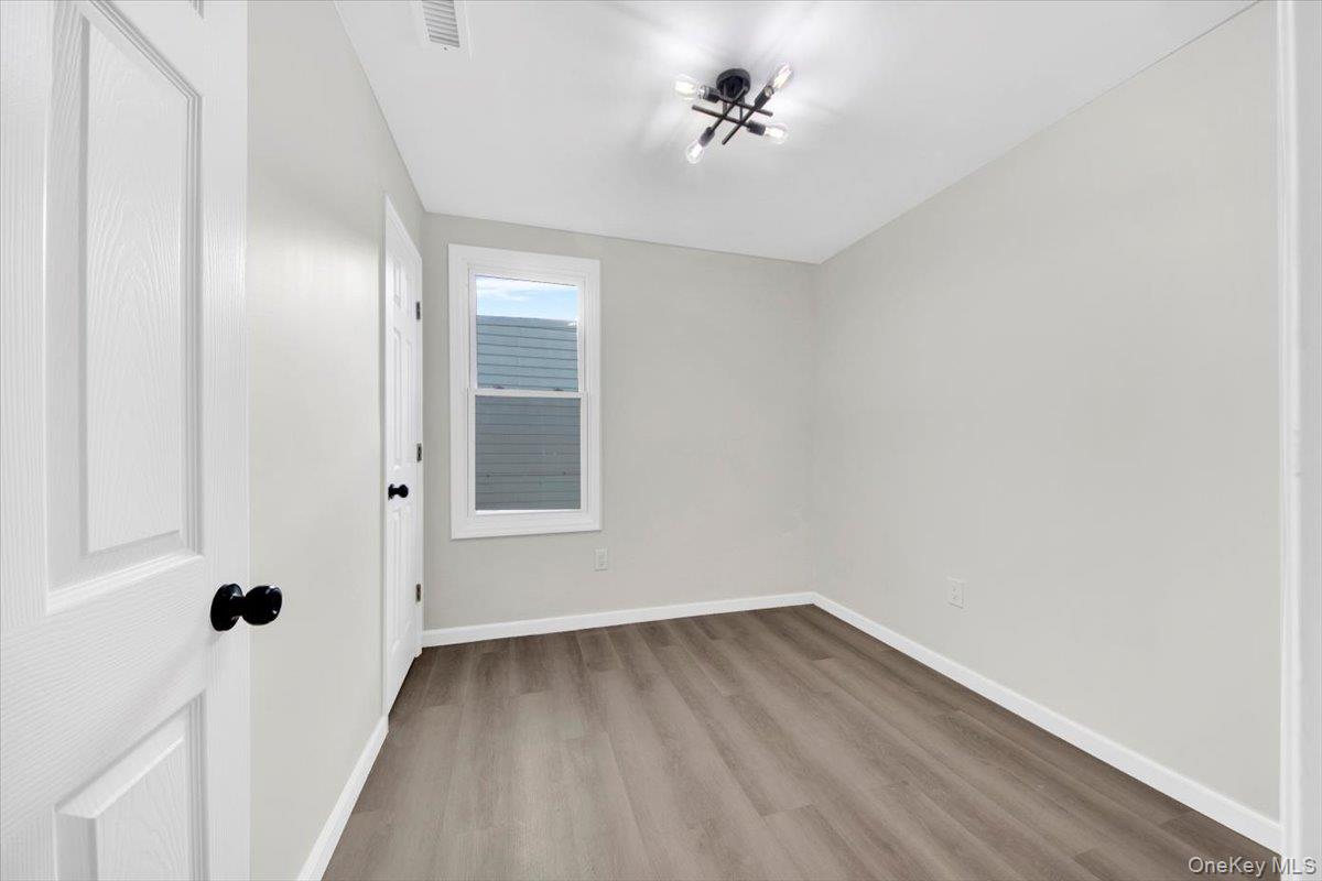 1625 Overing Street Bronx, NY 10461 - Photo 7 of 25 a view of an empty room with a window