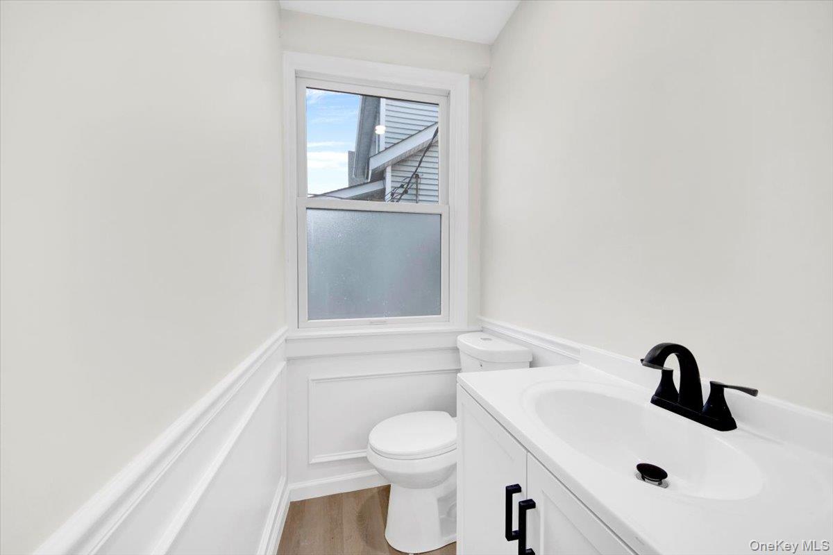 1625 Overing Street Bronx, NY 10461 - Photo 8 of 25 a bathroom with a sink a toilet and vanity