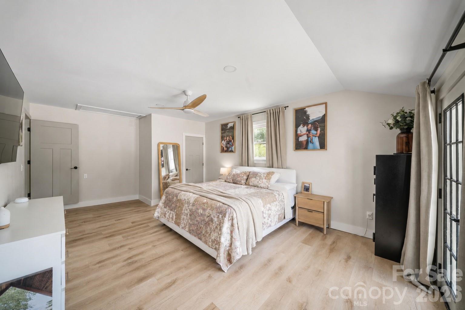 97 Paul Holland Road Canton, NC 28716 - Photo 22 of 35 a spacious bedroom with a bed and a refrigerator
