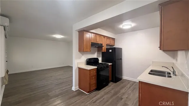 a kitchen with granite countertop a stove and a refrigerator