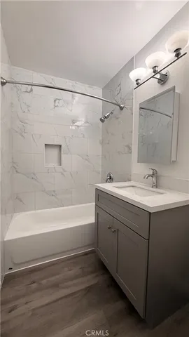 a bathroom with a sink mirror toilet and bathtub