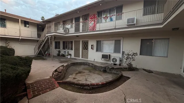a view of a house with backyard porch and sitting area