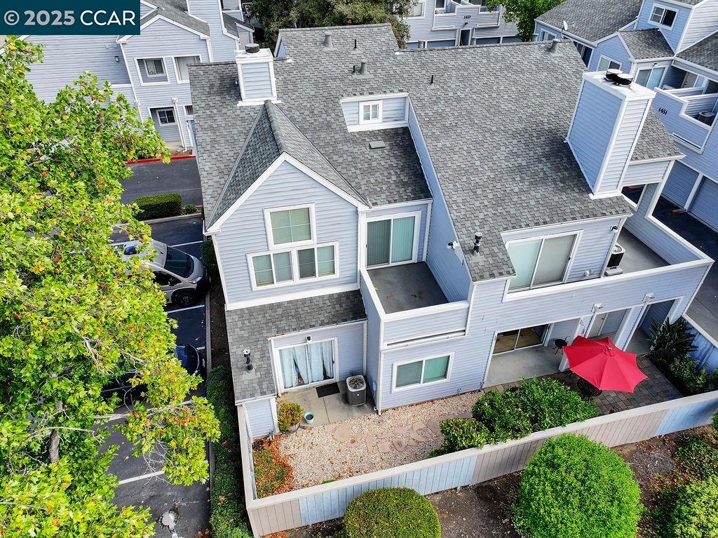 an aerial view of a house with a yard and potted plants
