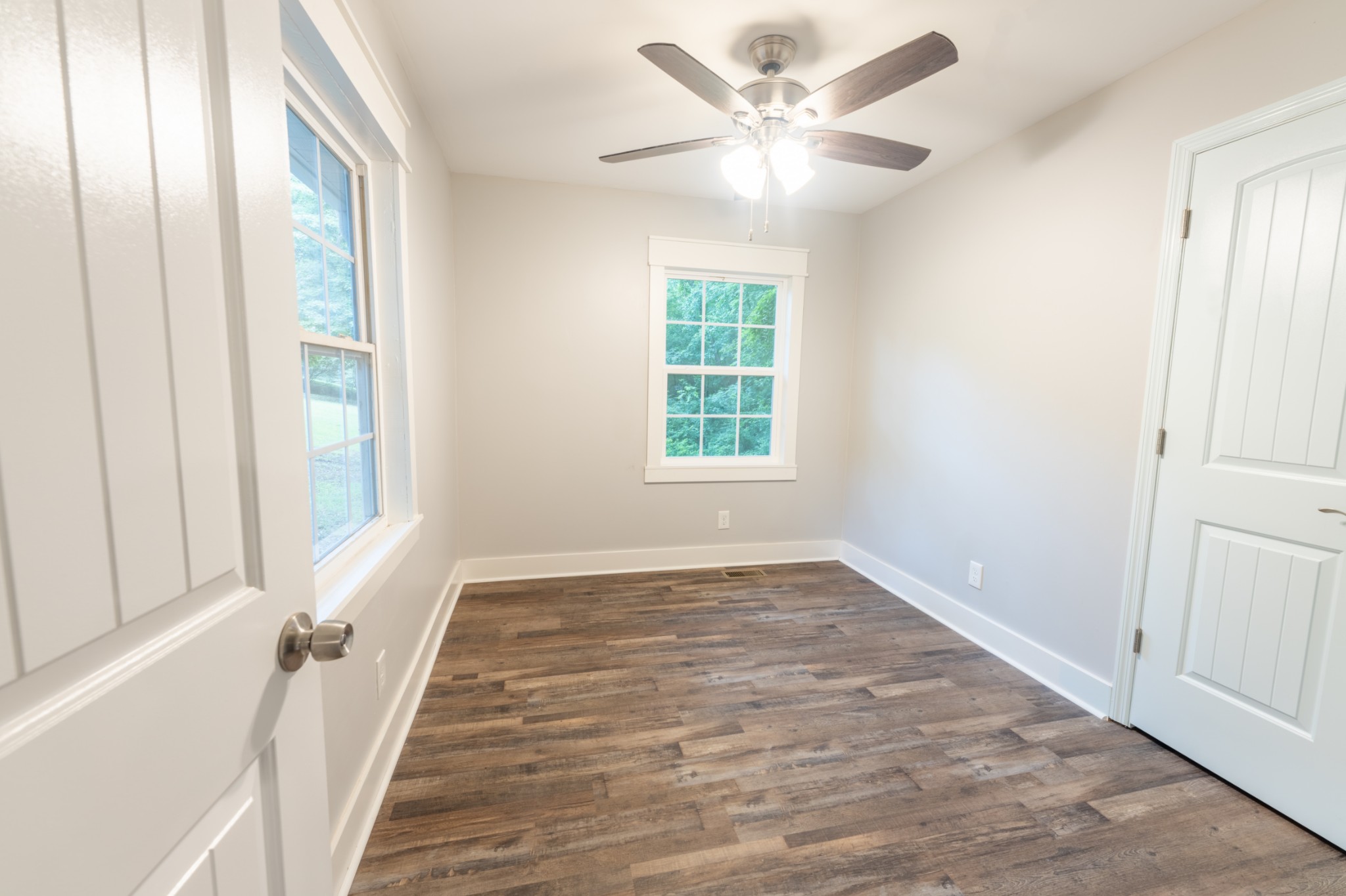 121 Smith Road Winchester, TN 37398 - Photo 25 of 31 an empty room with wooden floor fan and windows