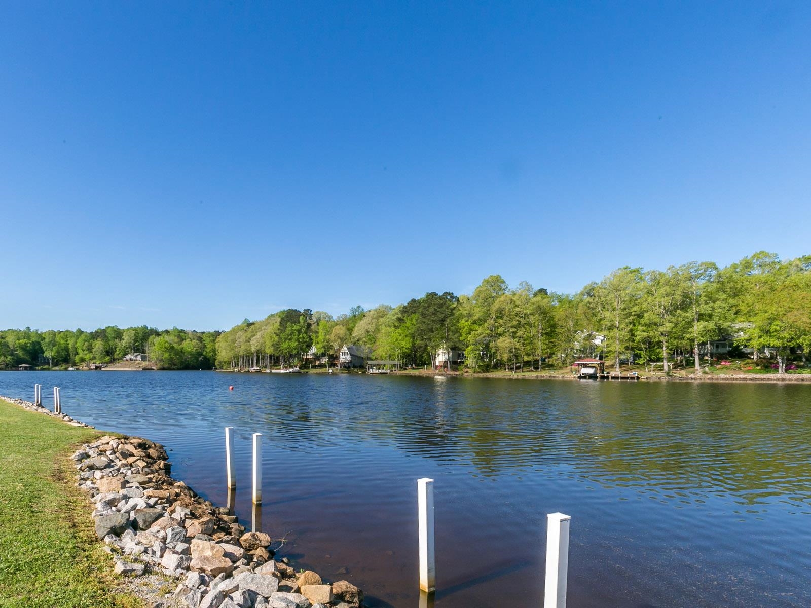 144 Sequoia Drive Louisburg, NC 27549 - Photo 7 of 10 a view of a lake with houses in the back