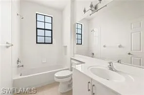 a bath room with a toilet a sink and a bath tub