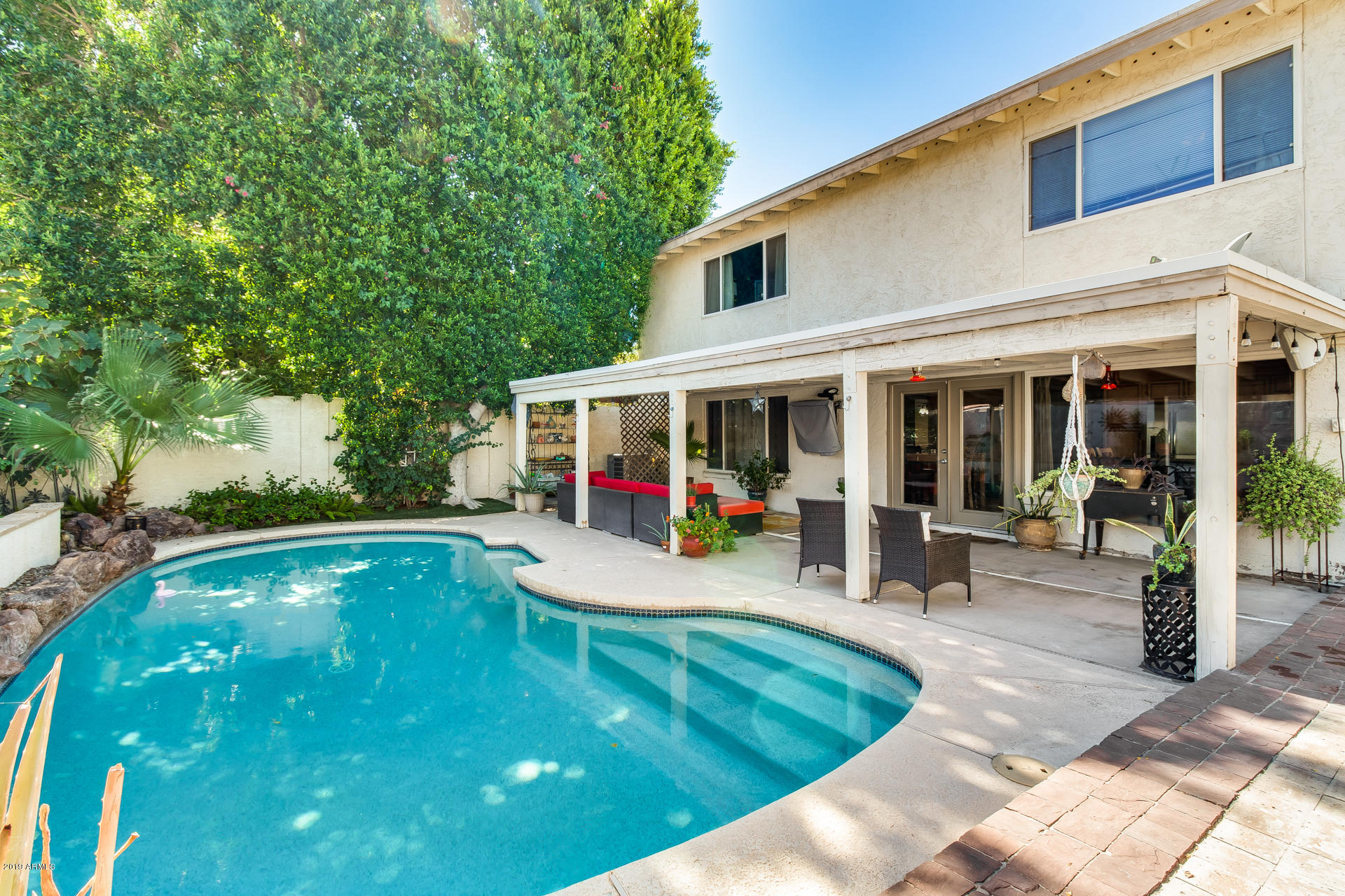 5615 South Crows Nest Road Tempe, AZ 85283 - Photo 25 of 44 a view of a swimming pool with chair and tables