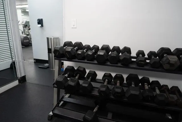 a view of a big room with windows and chandelier