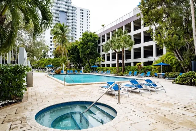 a view of swimming pool with outdoor seating and plants