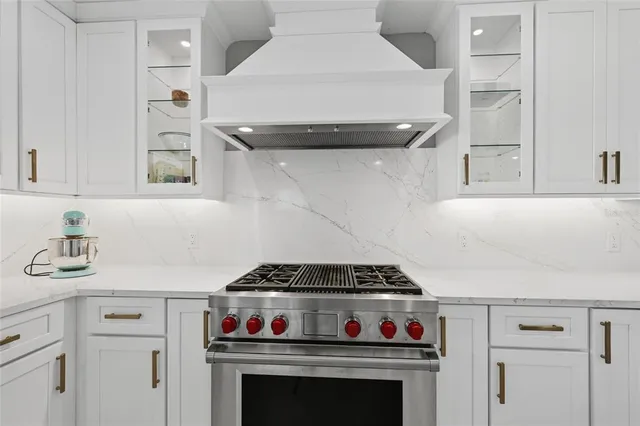 a kitchen with stainless steel appliances a stove and cabinets