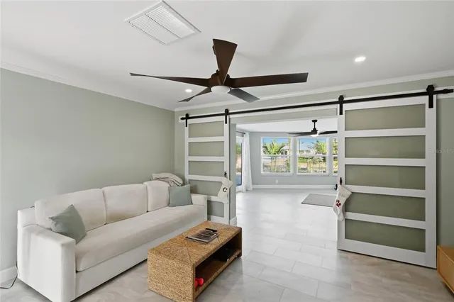 a living room with furniture and a ceiling fan