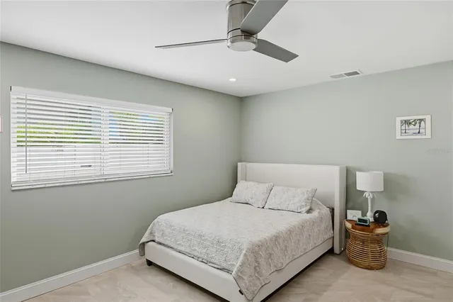 a bedroom with a bed and a tv