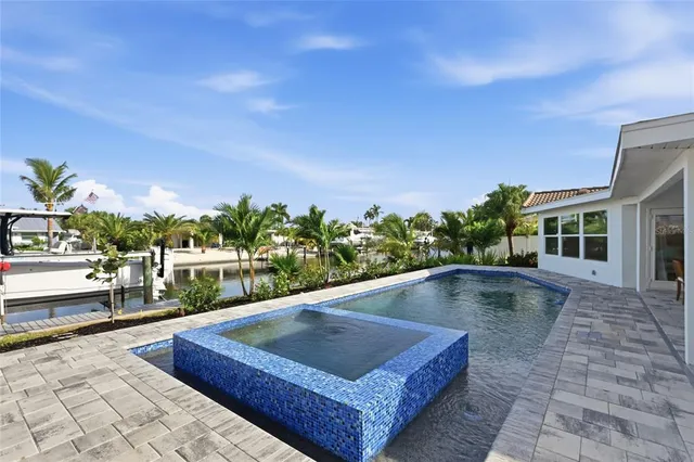 a view of a swimming pool with an outdoor seating