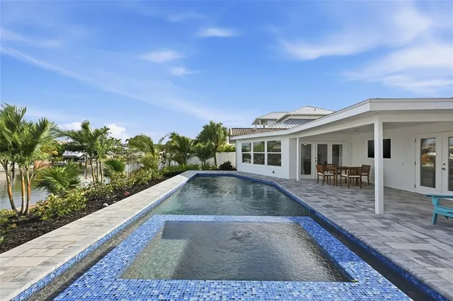 a view of a house with swimming pool and sitting area